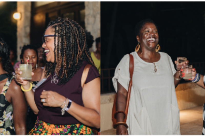 Black women standing, laughing, and smiling together